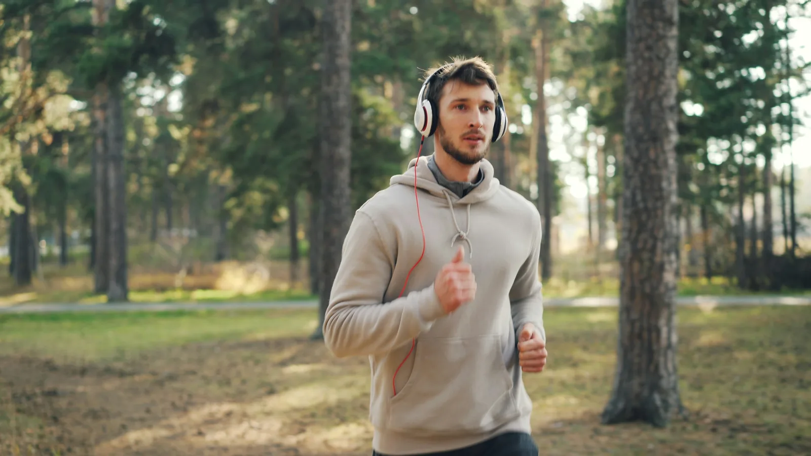 A man running through a forest, representing a personal fitness journey